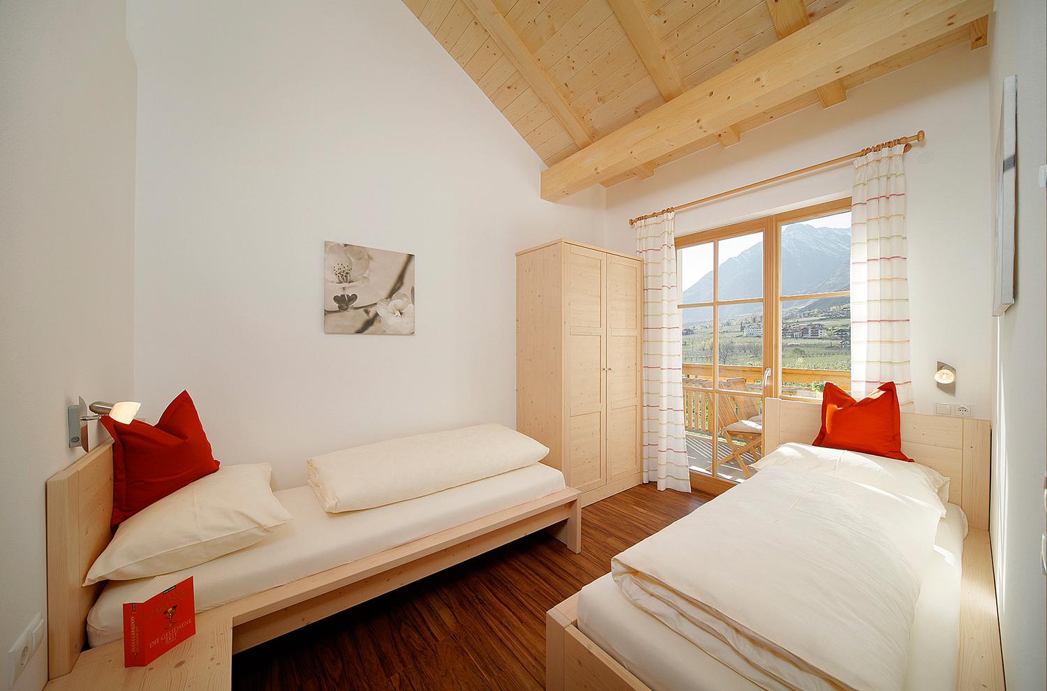 bedroom with two single beds and balcony