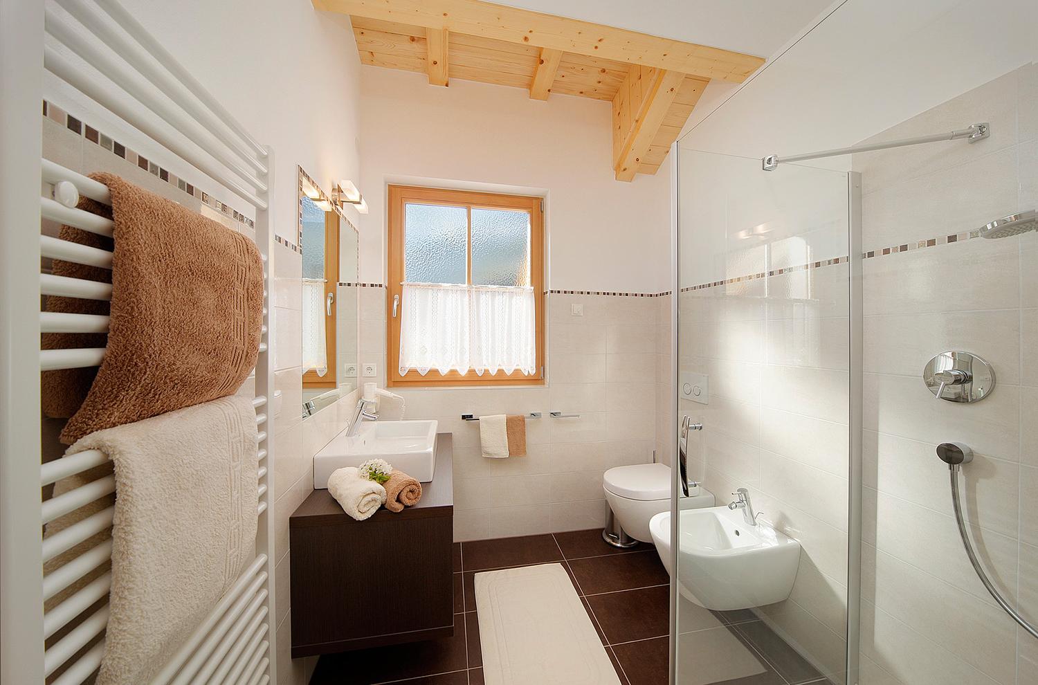 bathroom with shower and window